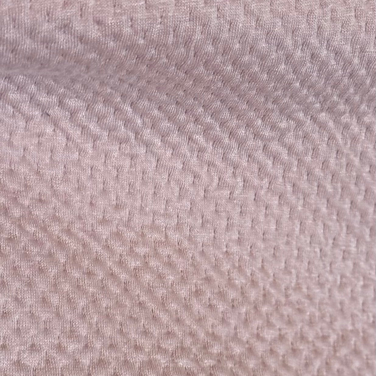 Close-up of a textured beige fabric surface