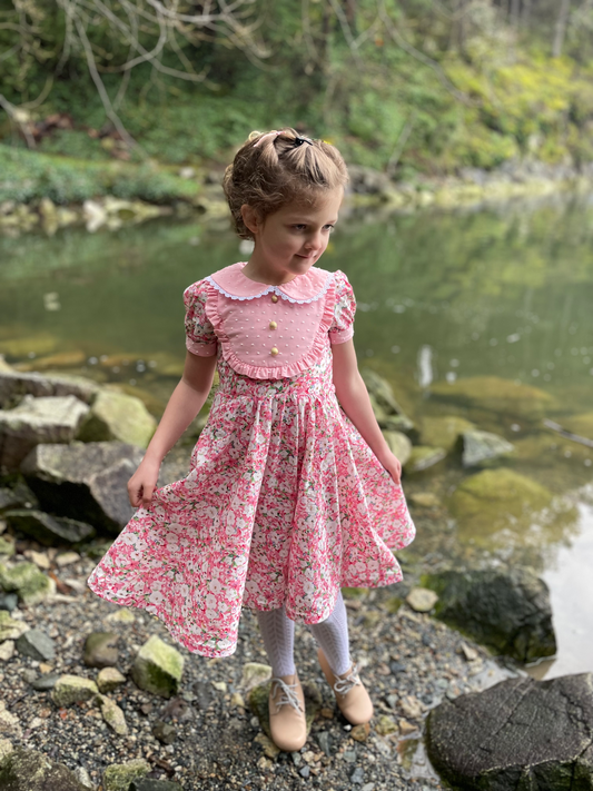 Heirloom pink floral dress on a child with a peter pan collar and lace detail 