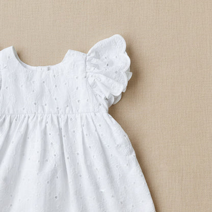 White dress with ruffled sleeves on a light gray background