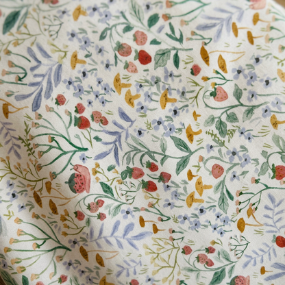 Floral patterned fabric with colorful flowers and leaves on a white background