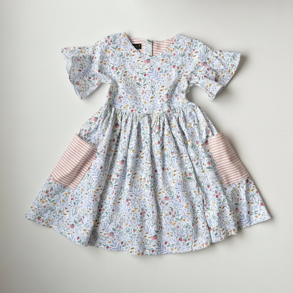 Floral dress with ruffled sleeves and pink striped accents on a light background