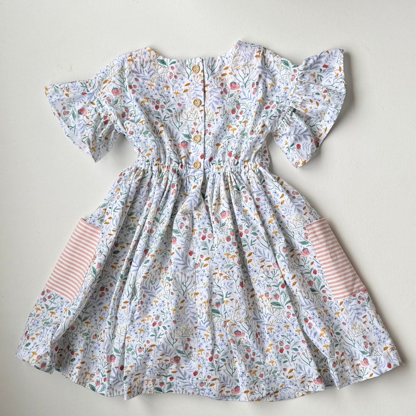 Floral dress with striped sleeves on a light background