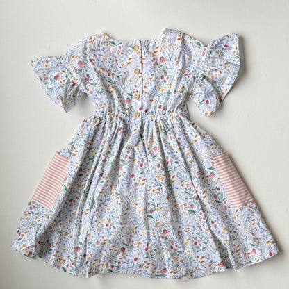 Floral dress with striped sleeves on a light background