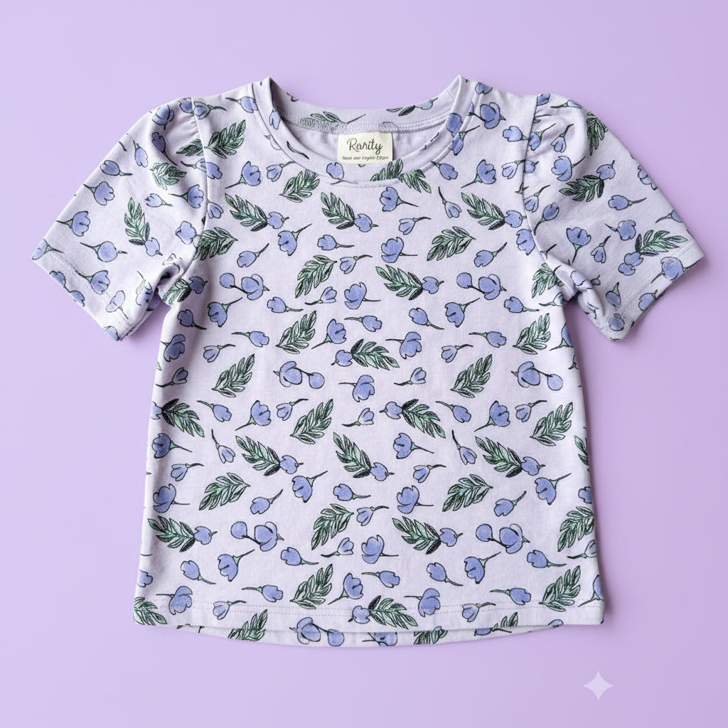 Children's shirt with floral pattern on a plain background