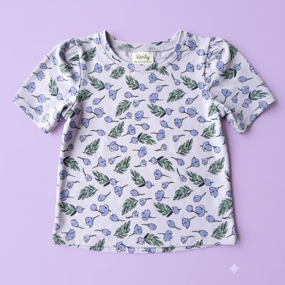 Children's shirt with floral pattern on a plain background
